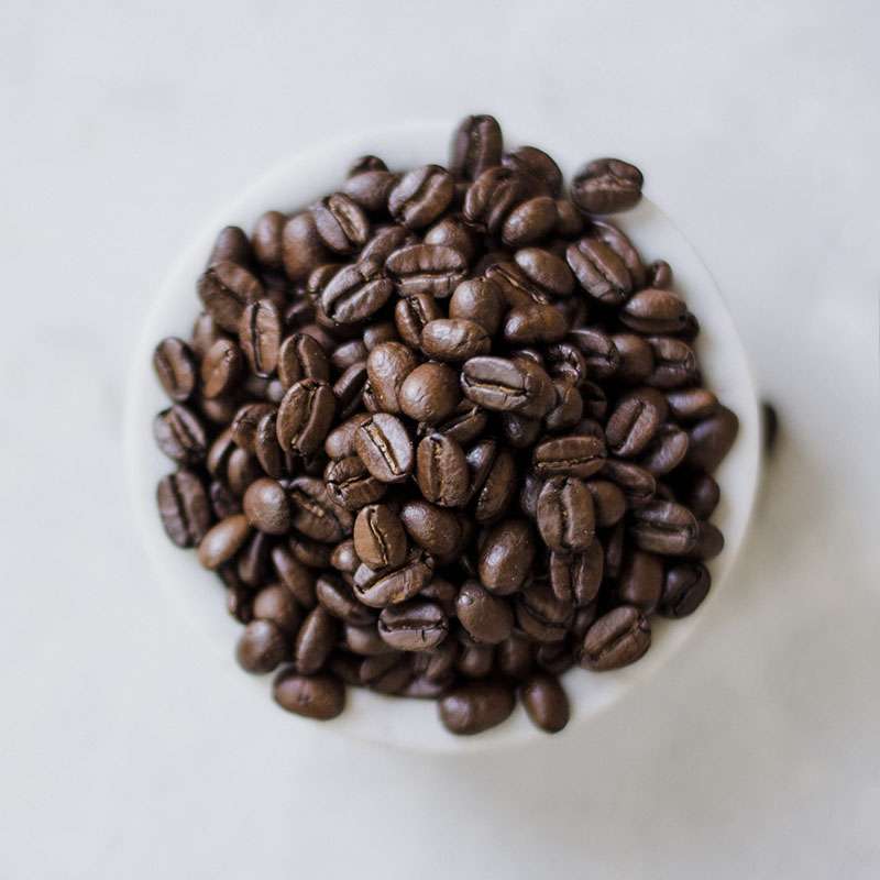 coffee mug filled with coffee beans