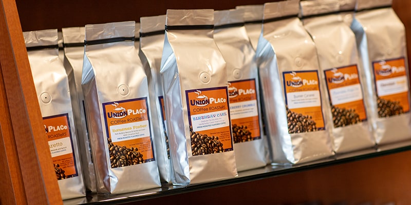 A shelf full of different coffee varieties at Union Place Coffee Roasters