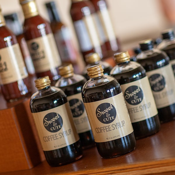 Shelf at Union Place Coffee Roasters with bottles of Sweet & Cute Coffee Syrup