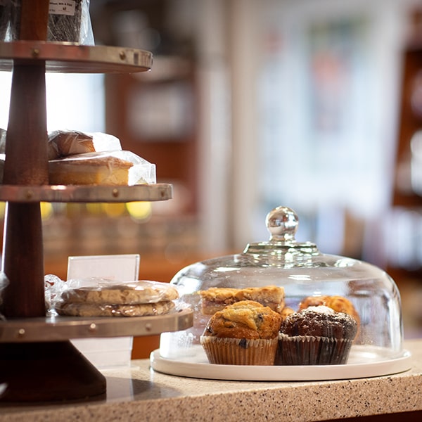 A glass dome with freshly baked muffins at Union Place Coffee Roasters