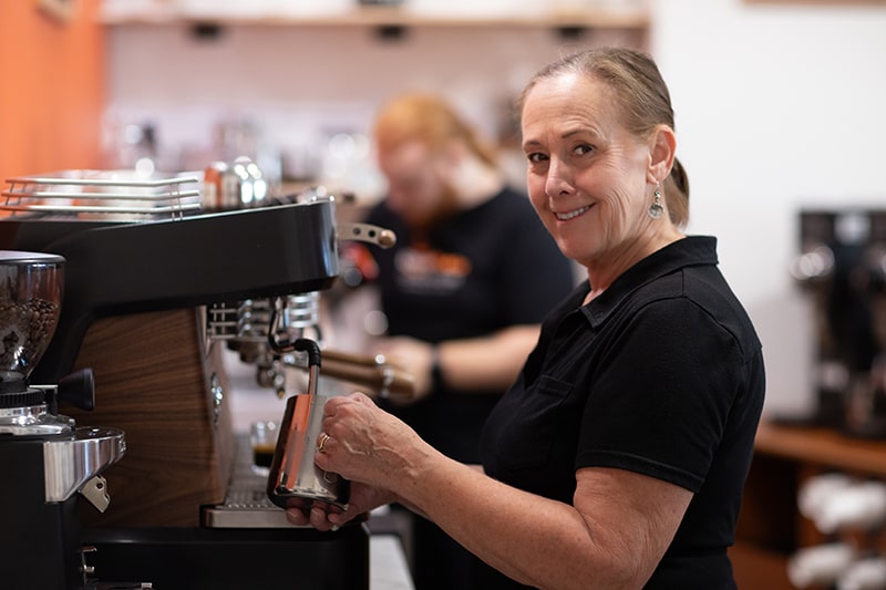 Laurie making an espresso beverage at Union Place Coffee Roasters